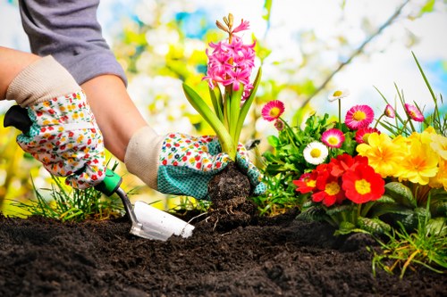 Gardeners working safely with tools and protective equipment